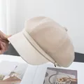 Close-up of beige wool octagonal newsboy hat featuring a stylish faux leather brim - Beige
