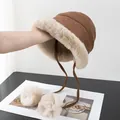 Detailed view of winter plush earflap hat with faux fur lining and soft pompom ties - M (56-58cm) / Caramel color