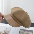 Close-up of brown newsboy hat featuring textured fabric and faux leather brim detail - Khaki