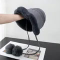 Detailed close-up of dark grey plush bucket hat with fluffy pom-poms and earmuffs - M (56-58cm) / Gray