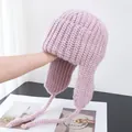 Detailed knit texture of pink winter trapper hat with ear flaps and braided ties - M (56-58cm) / Purple Pink