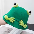 Close-up of cute green frog bucket hat featuring 3D eyes and hand embroidery details - Adult / Green