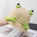 Detail of creative beige frog bucket hat with 3D plush eyes and cute green paw accents - Adult / Khaki