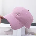 Detailed embroidery of letter U and smiley face on pink cotton baseball cap with white stitching - Adjustable / Pink
