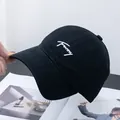Detail of black cotton baseball cap featuring white Funny script embroidery on the front - Adjustable / Black