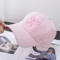 Close-up of pink baseball cap featuring delicate dark pink bow embroidery and cotton texture - Adjustable / Pink
