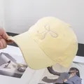 Detail of yellow cotton baseball cap with delicate bow embroidery and curved brim - Adjustable / Yellow