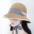 Detailed close-up of handmade straw hat with black and white gingham ribbon tie - Adjustable / Khaki Beige Hat Black White Plaid Ribbon