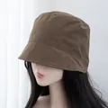 Detail view of brown short-brim bucket hat showing nylon texture and fine stitching lines - Adjustable / Coffee