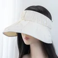 Close-up of pleated wide brim texture on a cream UV protection sun visor hat - Adjustable / Off White