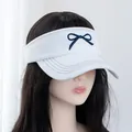Detail of embroidered navy bow on a white denim sun visor with decorative stitching - Adjustable / White