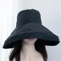 Close-up of women's black wide-brim sun hat with UV protection for superior face shading - Black