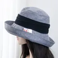 Detail showing the UV protection tag and grey linen texture of the wide-brim sun hat - Adjustable / Blue Gray