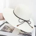 Close-up of woven paper straw texture on cream sun hat with brown decorative rope trim - Adjustable / Cream