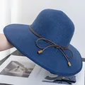 Detail of dark blue wide-brim straw hat with fine weave and brown bow with wooden beads - Adjustable / Navy Blue