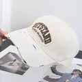 Detailed embroidery of OUTSTAND letters on a distressed cotton baseball cap - Adjustable / Beige