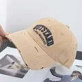 Close-up of distressed khaki cotton baseball cap with embroidered OUTSTAND lettering - Adjustable / Khaki