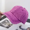 Close-up of vintage purple washed baseball cap with distressed edge details and cotton texture - Rose Red