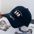 Detailed embroidery of three cartoon rabbits on a navy cotton baseball cap for women - Adjustable / Navy Blue