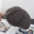Detail view of washed cotton fabric and panel stitching on a charcoal grey newsboy cap - M(56-58cm) / Coffee