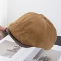 Detail of vintage khaki corduroy newsboy cap with brown leather brim texture - Khaki