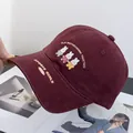 Close-up of cute rabbit embroidery and sports text on a burgundy cotton baseball cap - Adjustable / Burgundy