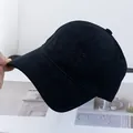 Detail of black cotton baseball cap with tonal embroidery on a minimalist magazine - Adjustable / Black