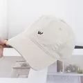 Détail de la casquette vintage avec broderie lettre W et bords effilochés usés - Réglable / Beige