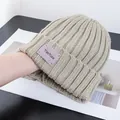 Detail of khaki ribbed knit beanie featuring a purple YOUTIAN woven patch on the fold - Stretchy / Beige Apricot