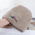 Detail of dachshund embroidery on oatmeal ribbed knit beanie with soft texture - Khaki