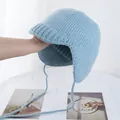 Macro shot of the light blue knit earflap hat showing its soft fuzzy texture and ribbed edges - M (56-58cm) / Blue