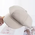Detailed close-up of a beige newsboy cap showing cotton fabric texture and octagonal top - Adjustable / Beige