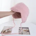 Close-up of pink knit pilot hat with earflaps and tie strings on a minimal background - M (56-58cm) / Pink