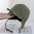 Detail of green windproof winter hat with fleece lining and adjustable ear flaps - Green