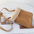 Detail of suede crossbody bag with faux shearling trim and gold buckle on knit background - 22*25 / Khaki