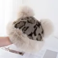 Detail of leopard print faux fur hat featuring soft texture and dual fluffy pom-poms - M(56-58cm) / Khaki