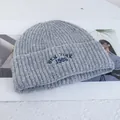 Close-up of gray wool knit beanie with New York 1986 embroidery detail and ribbed texture - Stretchy / Light Gray