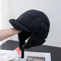 Close-up of quilted waterproof flight hat with metal air vents and buckle strap - Adjustable / Black