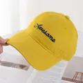 Detailed embroidery of blue Awesome text on bright yellow cotton baseball hat - Yellow
