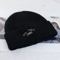 Detail of black wool knit beanie featuring white New York 1986 embroidery text - Stretchy / Black