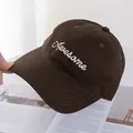 Detail view of American style baseball cap with white Awesome embroidery and curved brim - Coffee