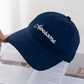 Detail of navy cotton baseball cap with white Awesome embroidery on an open magazine - Navy Blue