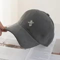 Detail shot of white astronaut embroidery on charcoal grey cotton canvas baseball cap - Dark Gray