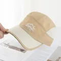 Detail of embroidered mountain logo on khaki quick-dry camper hat with color blocking - Adjustable / Khaki