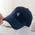 Close-up of white astronaut embroidery on premium navy blue cotton twill baseball cap - Navy Blue