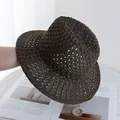 Detailed close-up of dark brown hollow crochet pattern on a breathable straw sun hat - Adjustable / Coffee