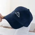 Detail of navy blue corduroy fabric with white mountain and youth embroidery on the cap - Navy Blue
