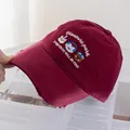 Close-up of wine red baseball cap with cartoon animal embroidery and frayed brim detail - Adjustable / Burgundy