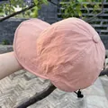 Detail of salmon nylon sun hat featuring adjustable drawstring and wide brim for outdoor use - Adjustable / Pink