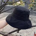 Detail of a black wide-brim sun hat with adjustable windproof drawstring for outdoor use - Adjustable / Black